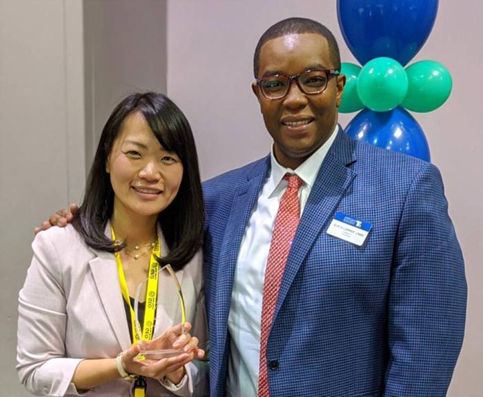 Photo of Ivan Harrell and Namiko Bagirimvano with award